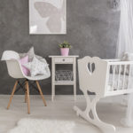 61076447 – shot of a modern grey baby room with white accessories
